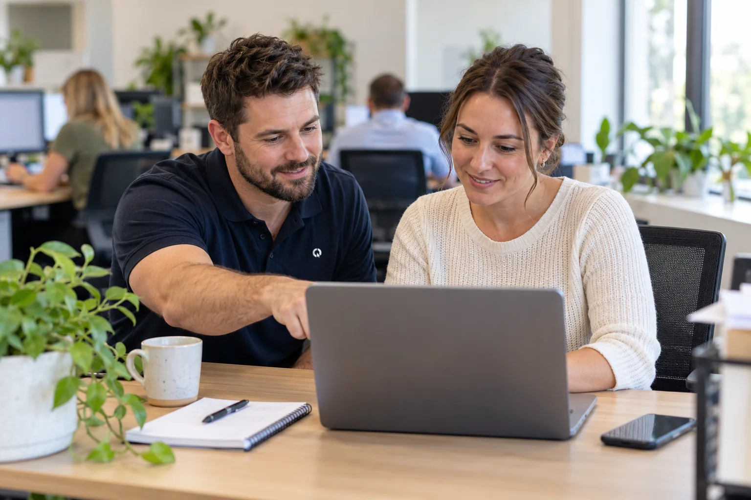 SEQ IT technician helping a staff member at her desk