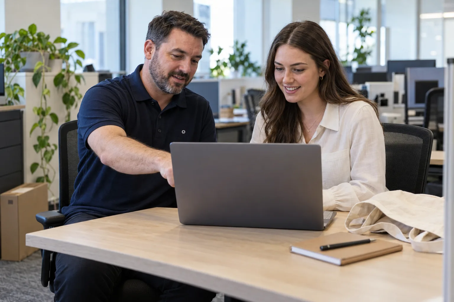 Technician setting up a laptop for a new staff member